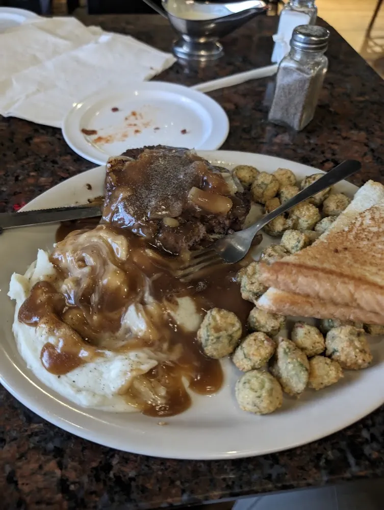 Hamburger Steak Dinner with Gravy Onions Mashed Potatoes Fried Okra and Texas Toast